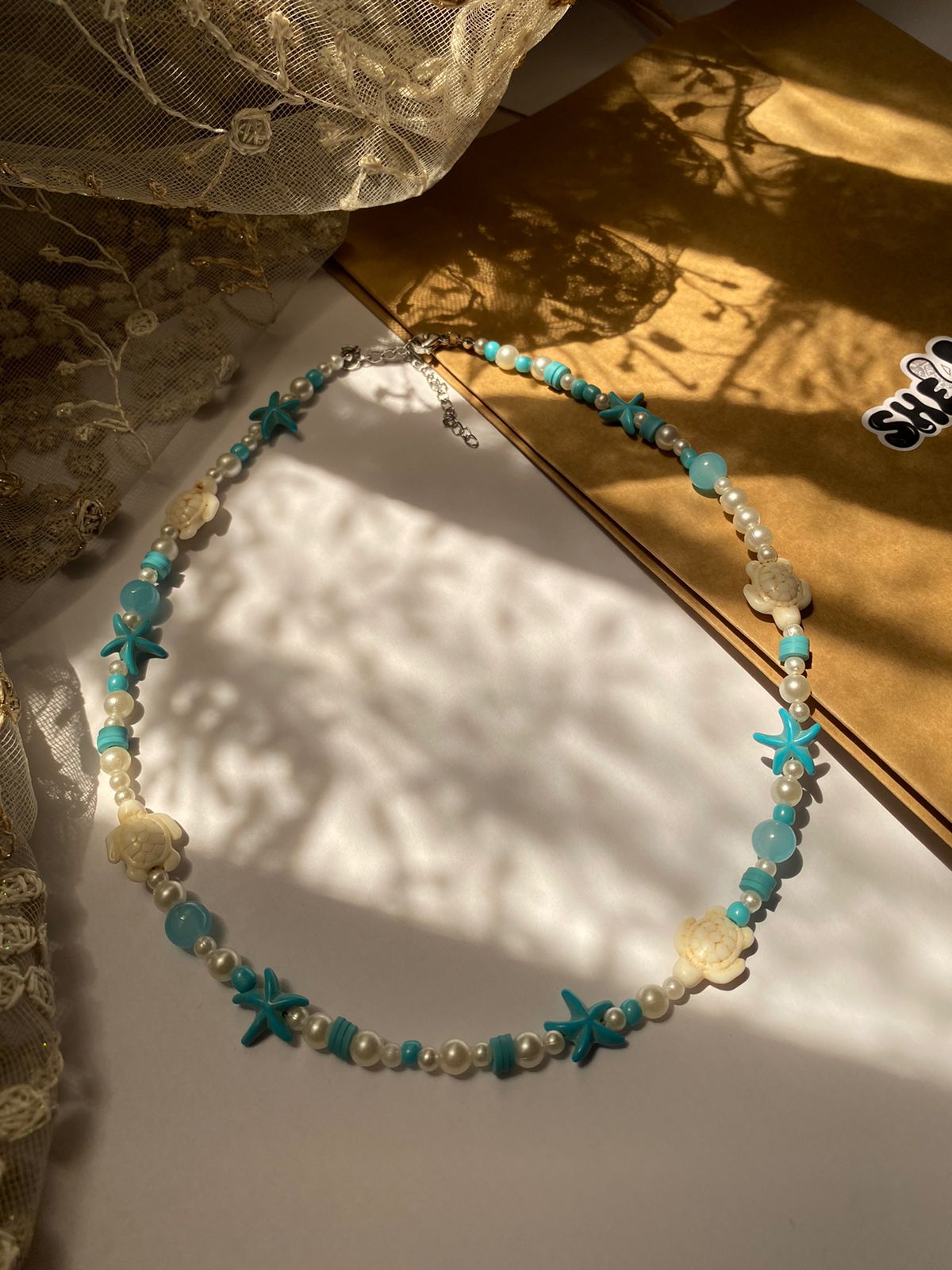 Handmade blue and white beaded turtle necklace with starfish by Shelluxe - Summer beach accessories